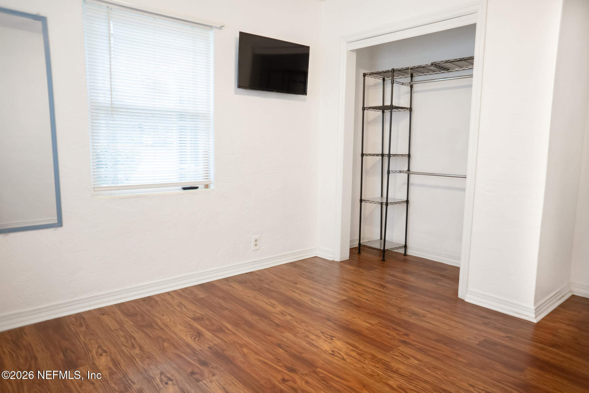 161 Southwest Jasmine Avenue Keystone Heights, FL 32656 - Photo 25 of 47 an empty room with wooden floor and windows
