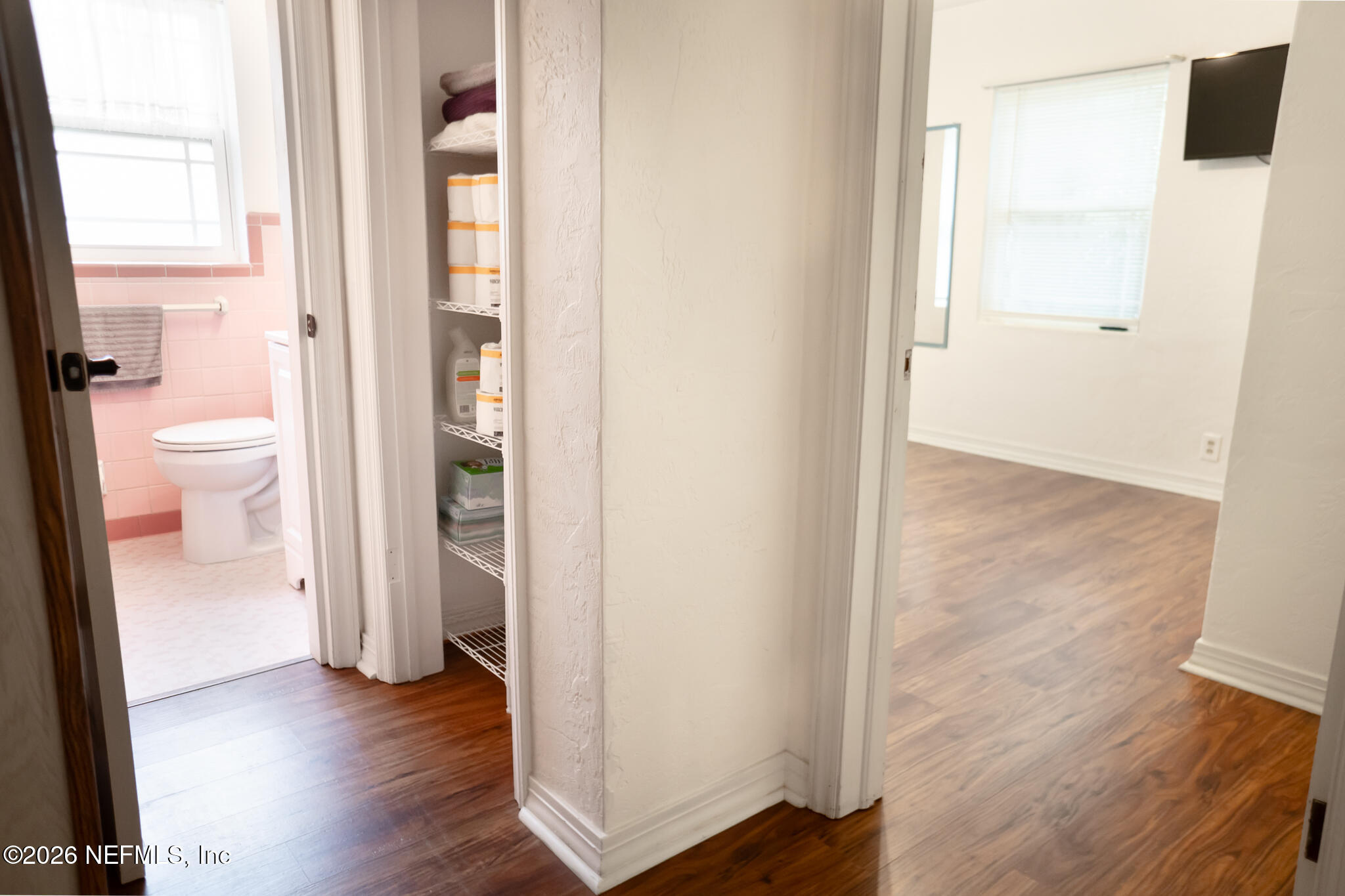 161 Southwest Jasmine Avenue Keystone Heights, FL 32656 - Photo 26 of 47 a view of a bathroom from a hallway with wooden floor