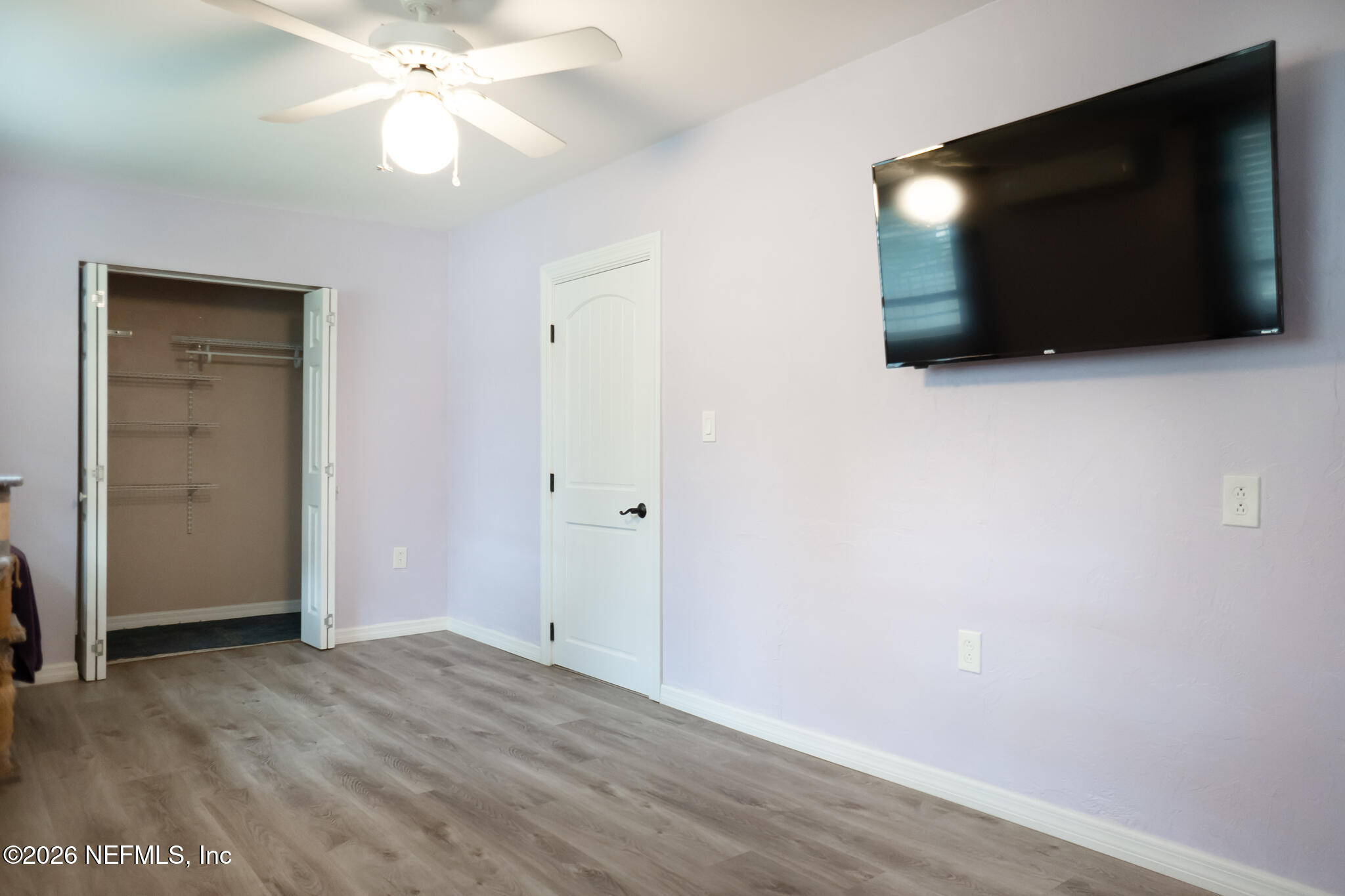 161 Southwest Jasmine Avenue Keystone Heights, FL 32656 - Photo 30 of 47 a view of an empty room with wooden floor and cabinet