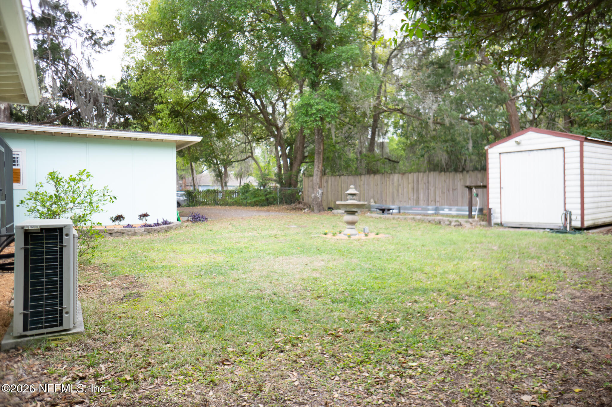 161 Southwest Jasmine Avenue Keystone Heights, FL 32656 - Photo 46 of 47 a backyard of a house with table and chairs