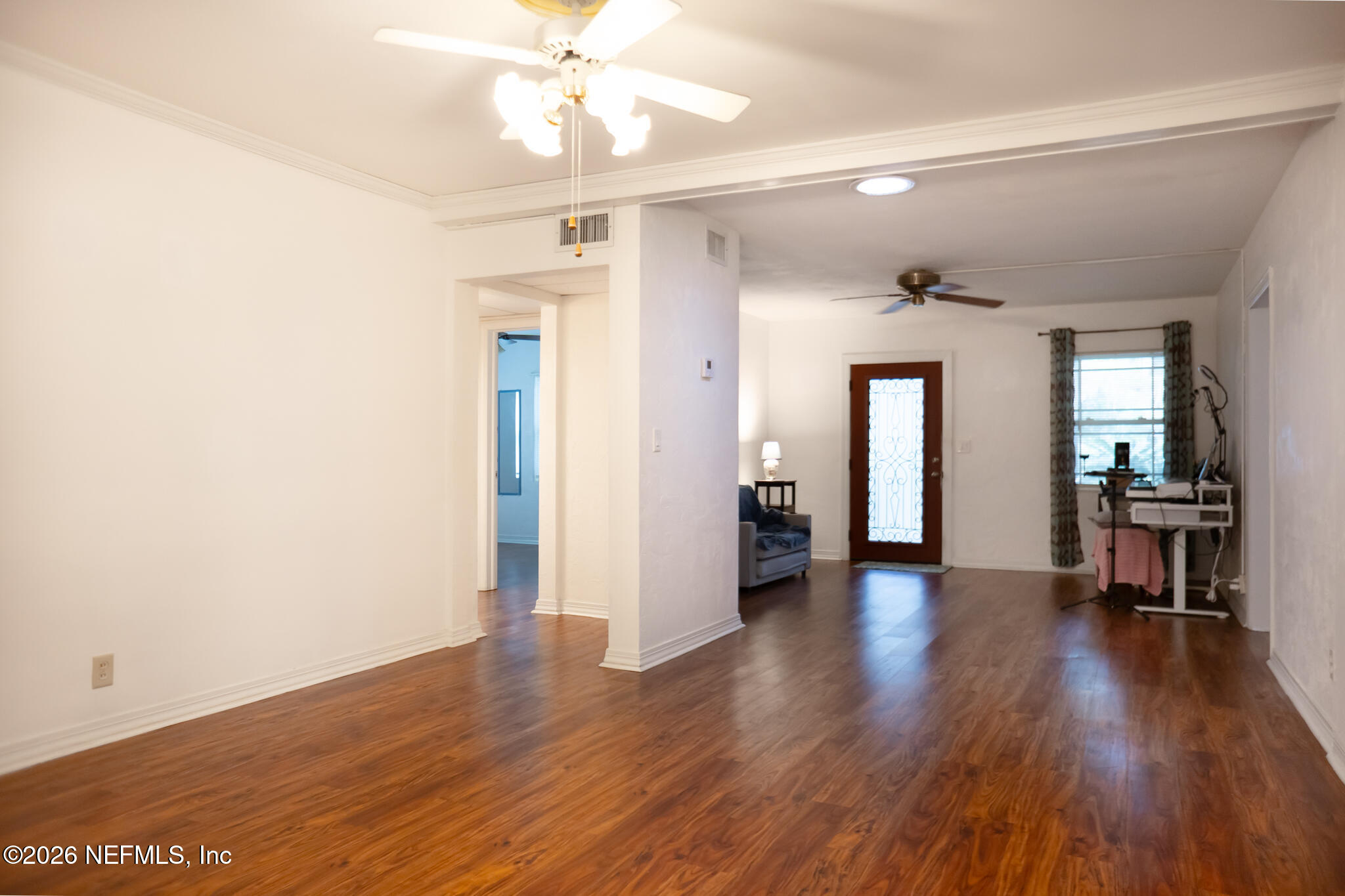 161 Southwest Jasmine Avenue Keystone Heights, FL 32656 - Photo 7 of 47 a view of a hallway with wooden floor and a chandelier