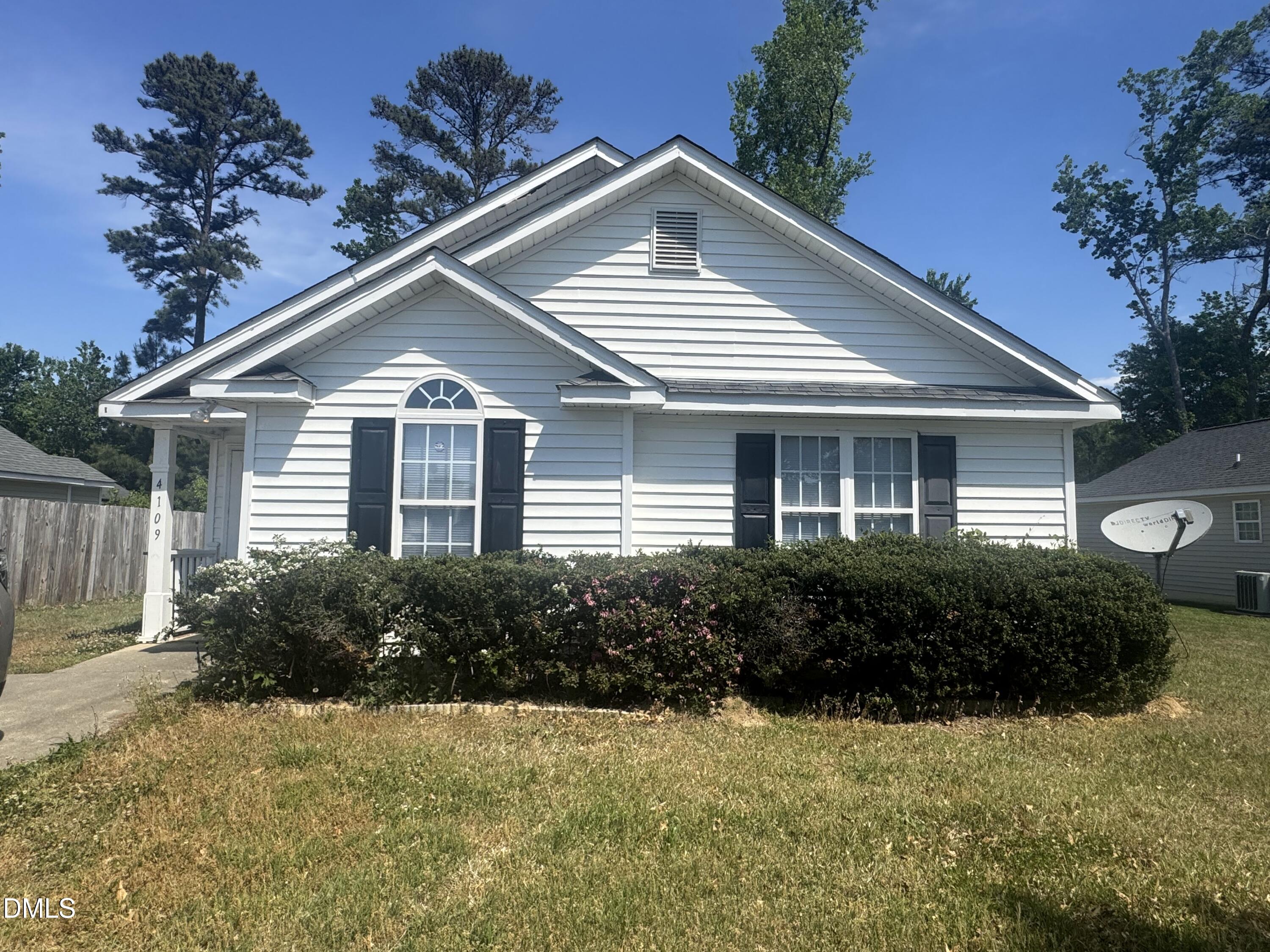 4109 Huntsmoor Lane Wilson, NC 27896 - Photo 1 of 26 a front view of a house with garden