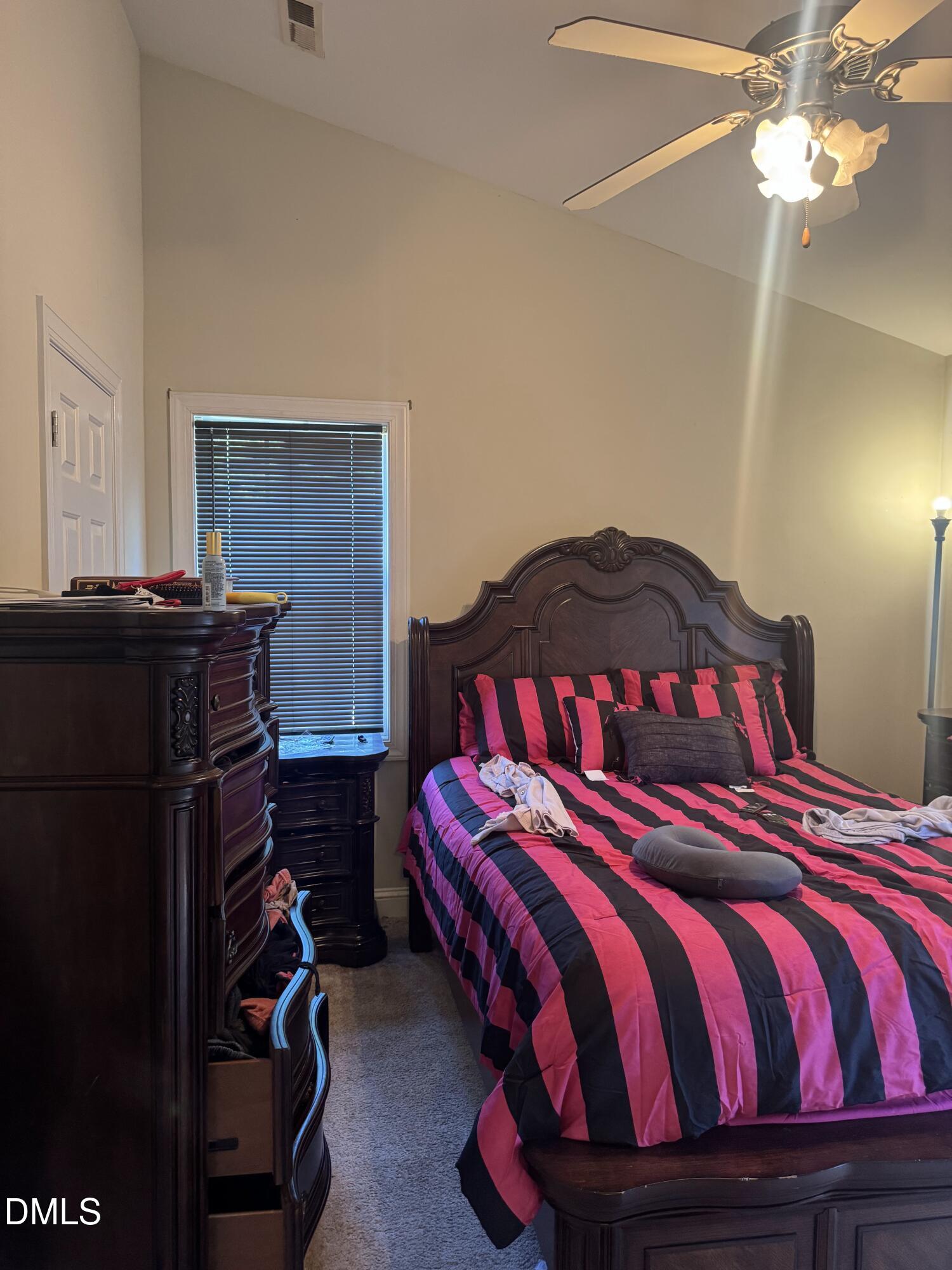 4109 Huntsmoor Lane Wilson, NC 27896 - Photo 11 of 26 a bedroom with a bed and a chandelier