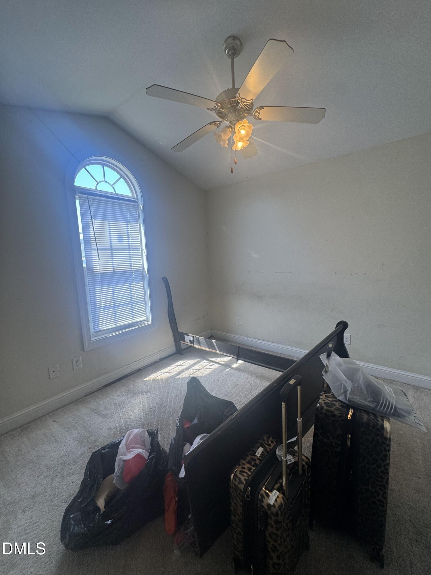 4109 Huntsmoor Lane Wilson, NC 27896 - Photo 14 of 26 a bedroom with a bed and a chandelier