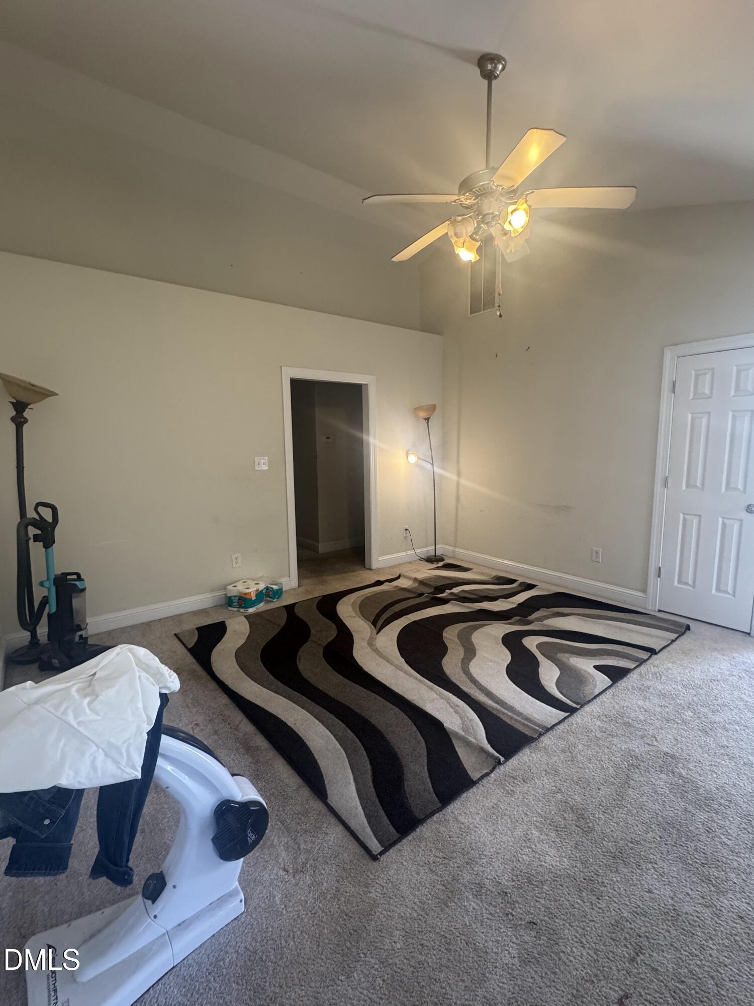 4109 Huntsmoor Lane Wilson, NC 27896 - Photo 3 of 26 a bedroom with a bed and a chandelier