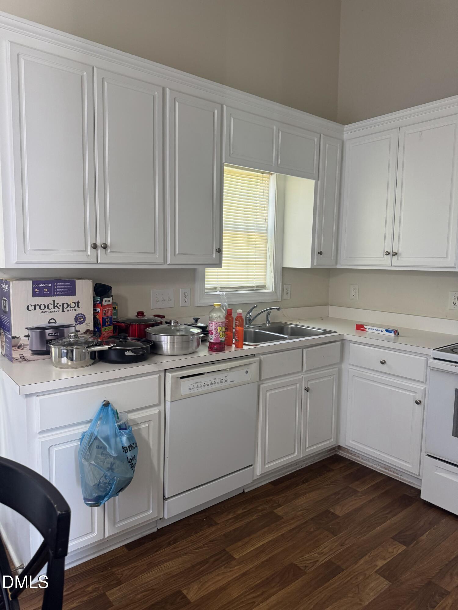 4109 Huntsmoor Lane Wilson, NC 27896 - Photo 7 of 26 a kitchen with granite countertop white cabinets sink and window