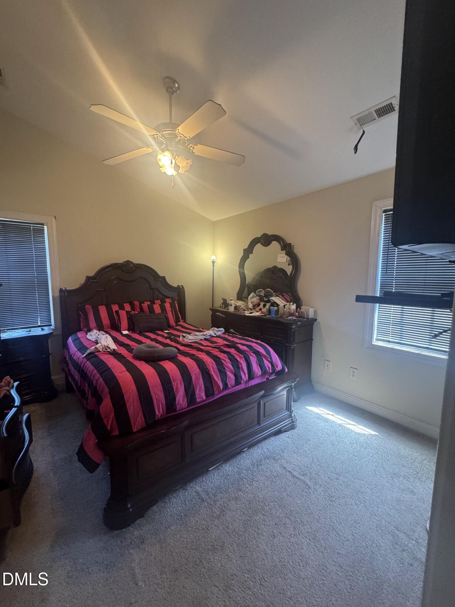 4109 Huntsmoor Lane Wilson, NC 27896 - Photo 10 of 26 a bedroom with a bed and dresser with mirror