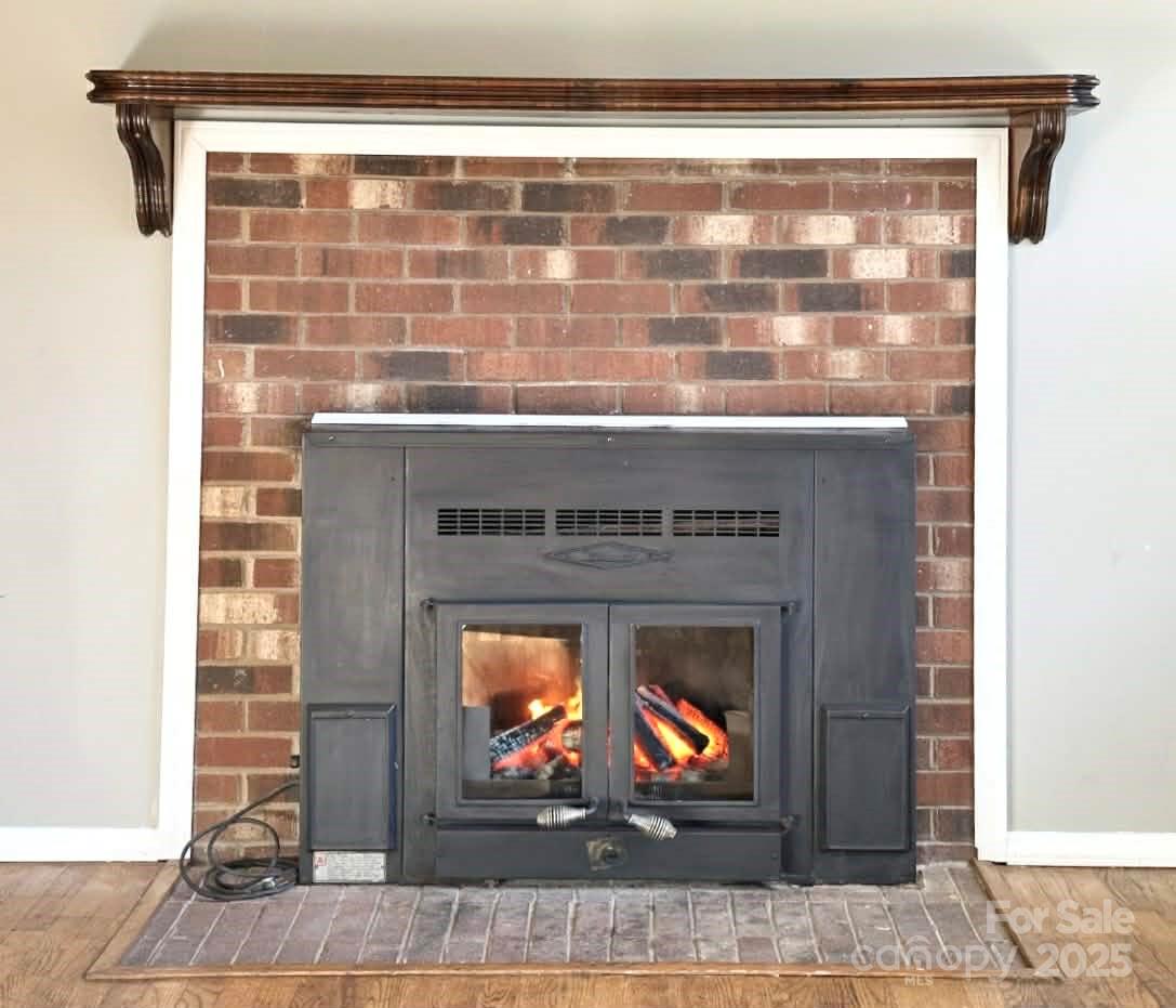 2238 Flatwood Road Lenoir, NC 28645 - Photo 4 of 12 a fireplace with a wooden floor