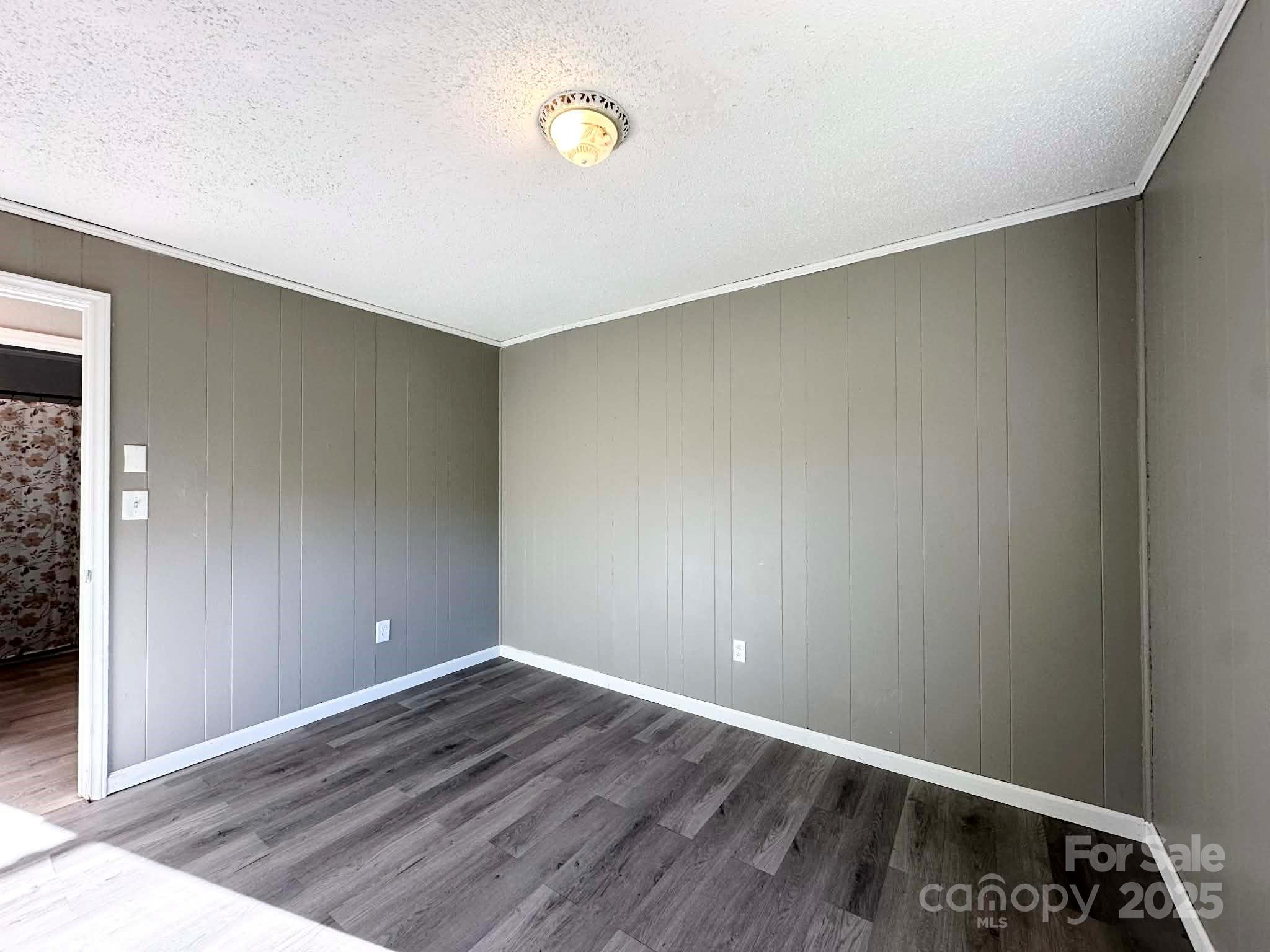 2238 Flatwood Road Lenoir, NC 28645 - Photo 10 of 12 an empty room with wooden floor and windows