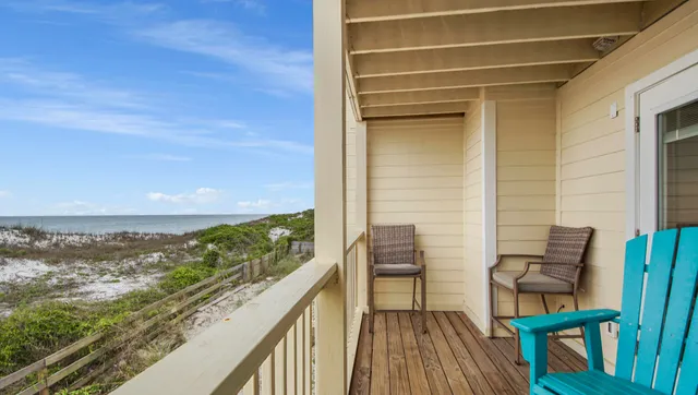 a view of balcony with two chairs and a table