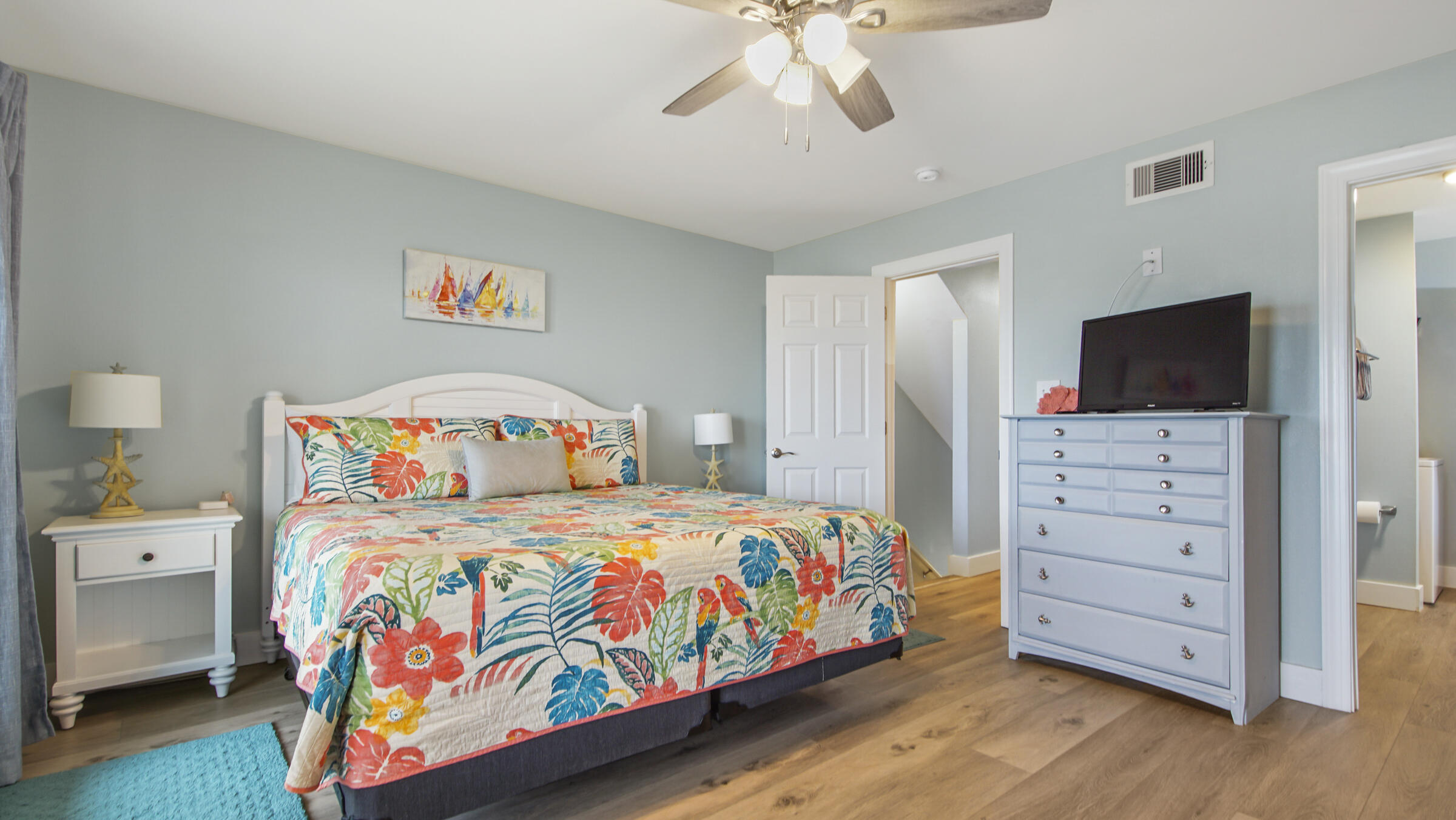 654 Seacliff Drive, Unit 4 Port St. Joe, FL 32456 - Photo 35 of 51 a bedroom with a bed and a flat tv screen on dresser