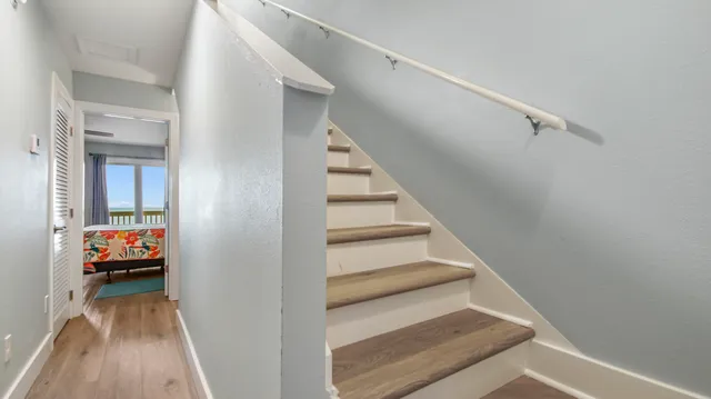 a bedroom with a bed and a flat tv screen on dresser