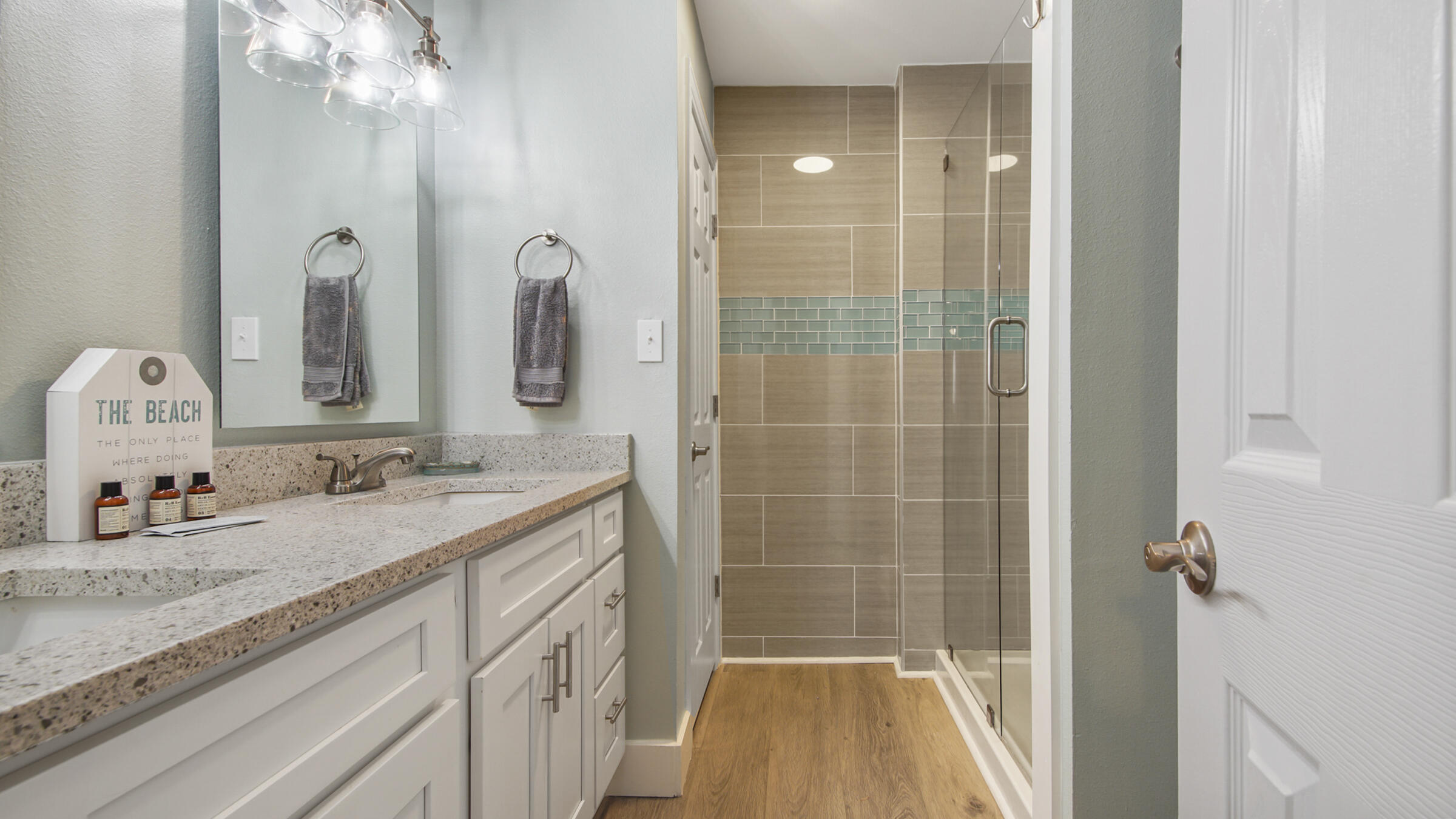 654 Seacliff Drive, Unit 4 Port St. Joe, FL 32456 - Photo 45 of 51 a bathroom with a granite countertop sink a mirror and shower