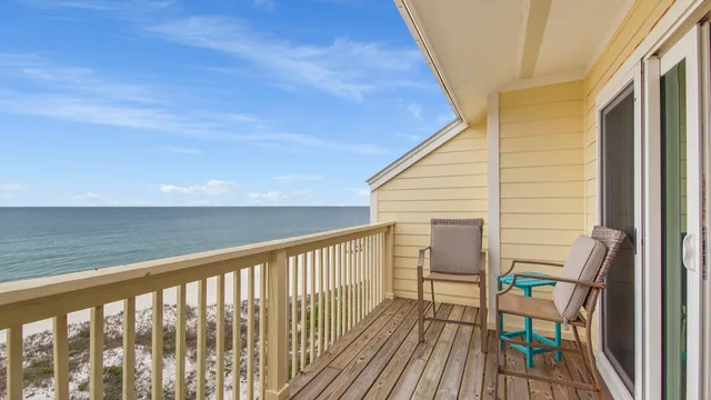 a view of a roof deck with wooden floor and fence