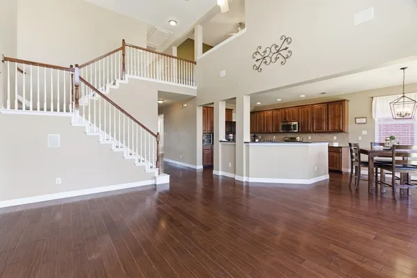 a view of a kitchen with furniture and wooden floor