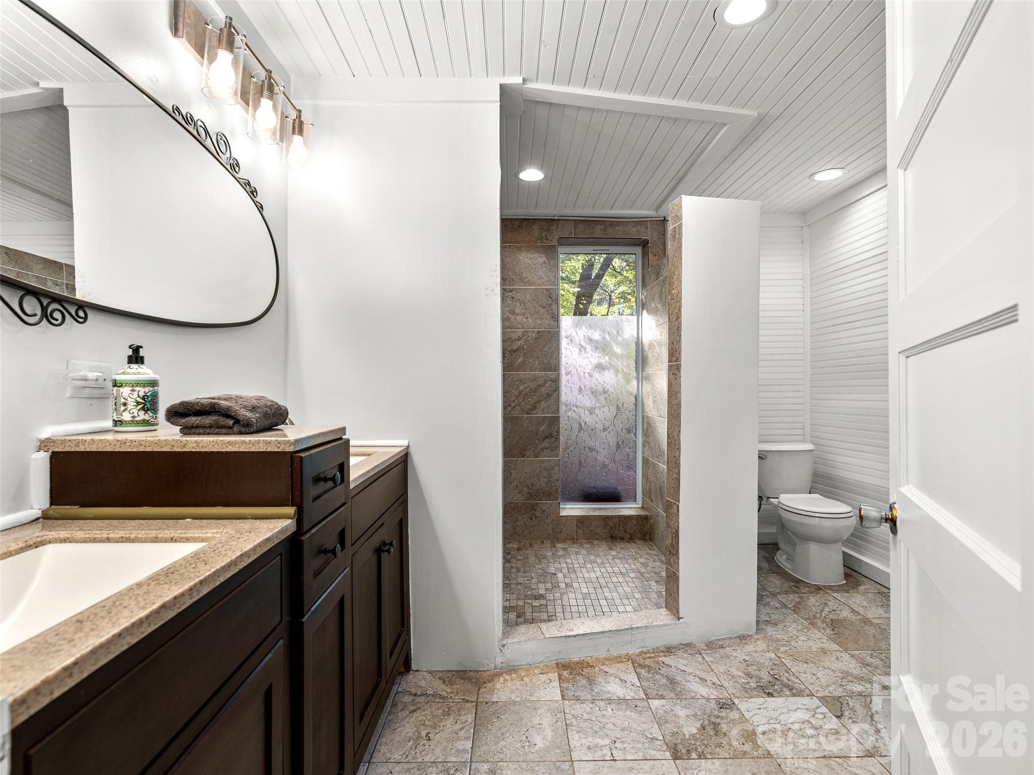 206 Chestnut Hill Road Gerton, NC 28735 - Photo 46 of 48 a bathroom with a granite countertop sink toilet and shower
