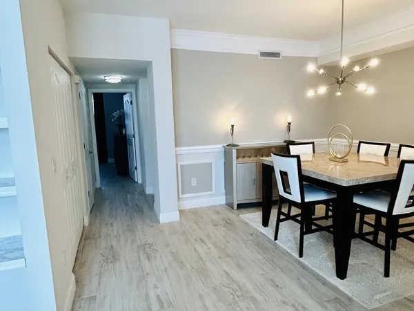 a view of a dining room with furniture and wooden floor