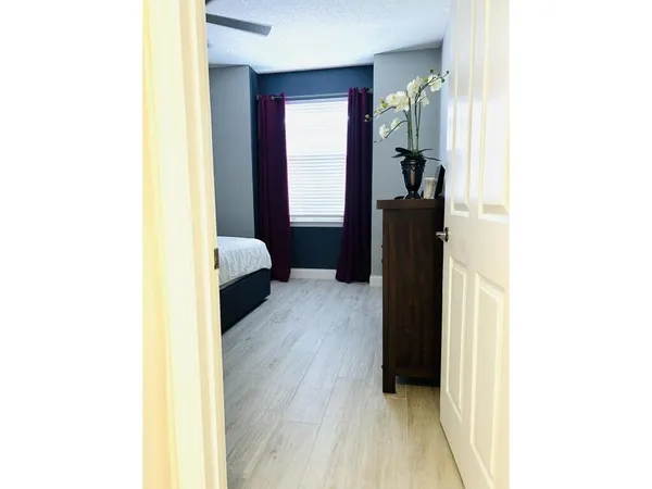 a living room with a bed and a dresser