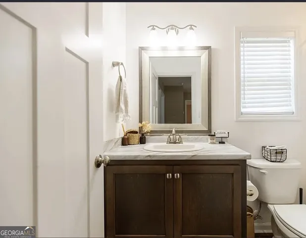 an empty room with a ceiling fan and windows