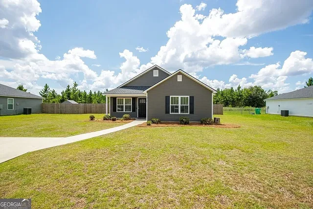 a front view of house with yard and swimming pool