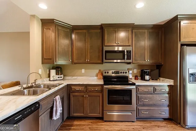 a view of an empty room with a kitchen