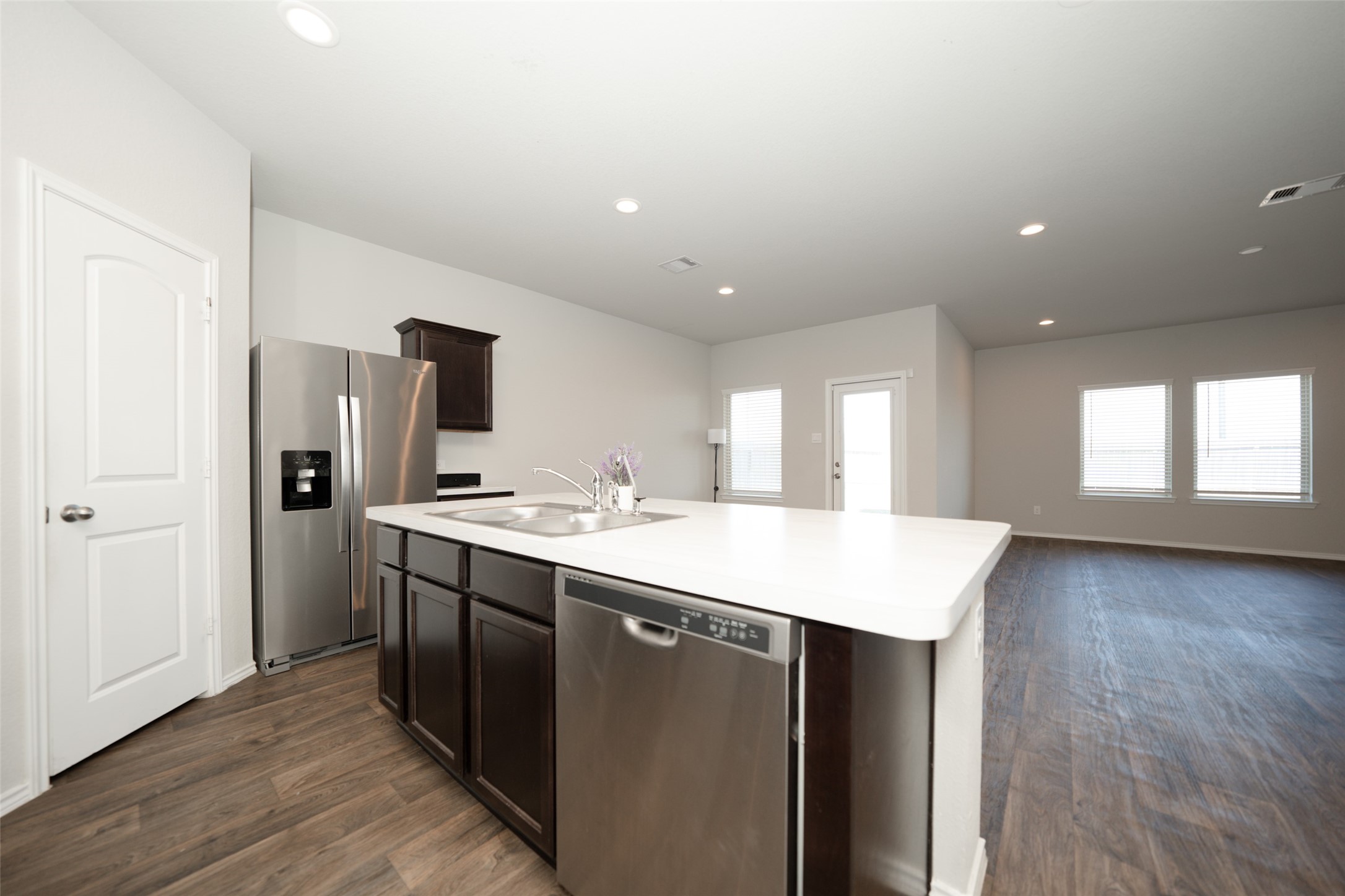 20818 Edmeston Way Katy, TX 77449 - Photo 11 of 32 a kitchen with a sink a refrigerator and wooden floor