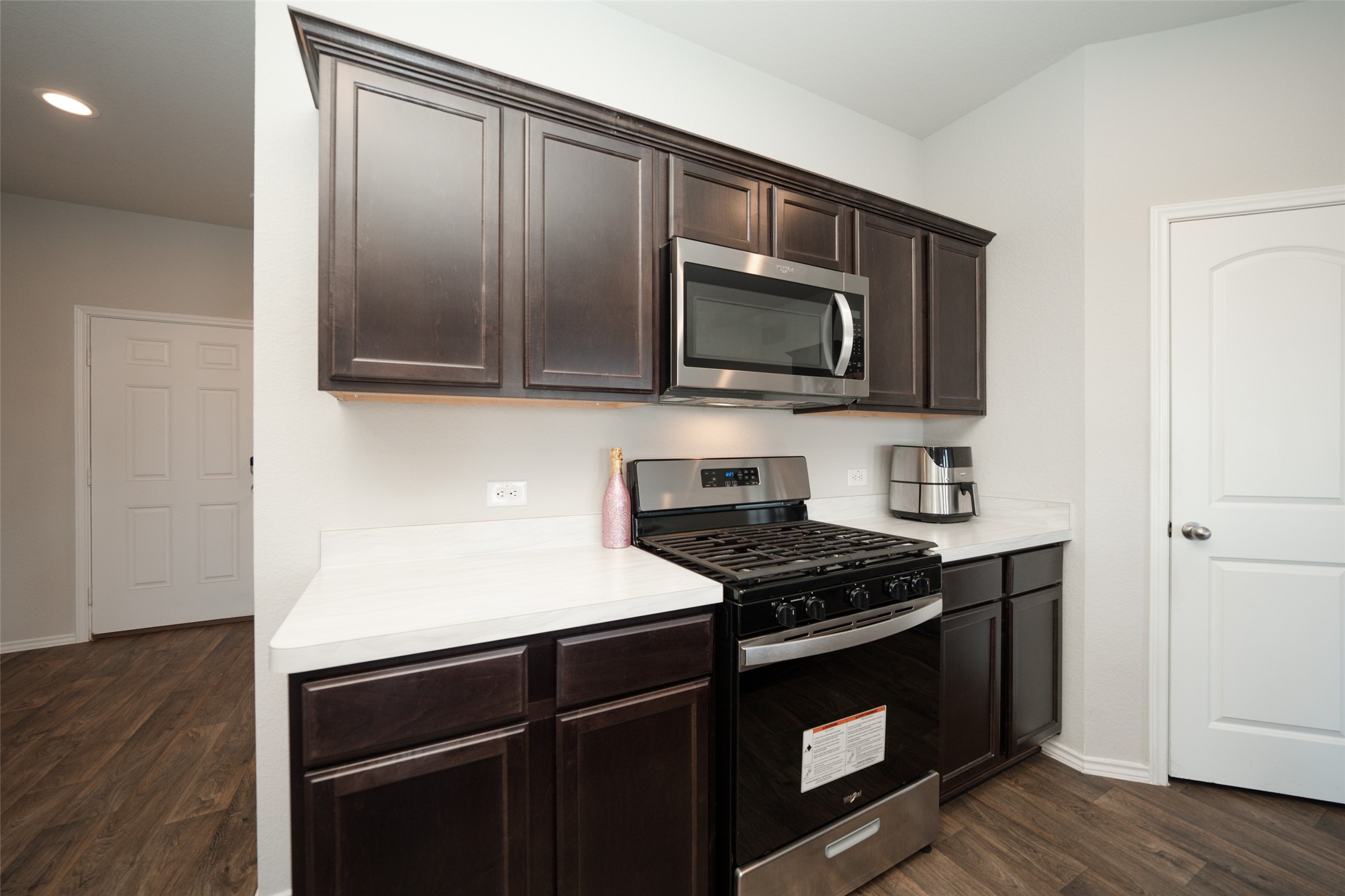 20818 Edmeston Way Katy, TX 77449 - Photo 12 of 32 a kitchen with granite countertop a stove and a microwave