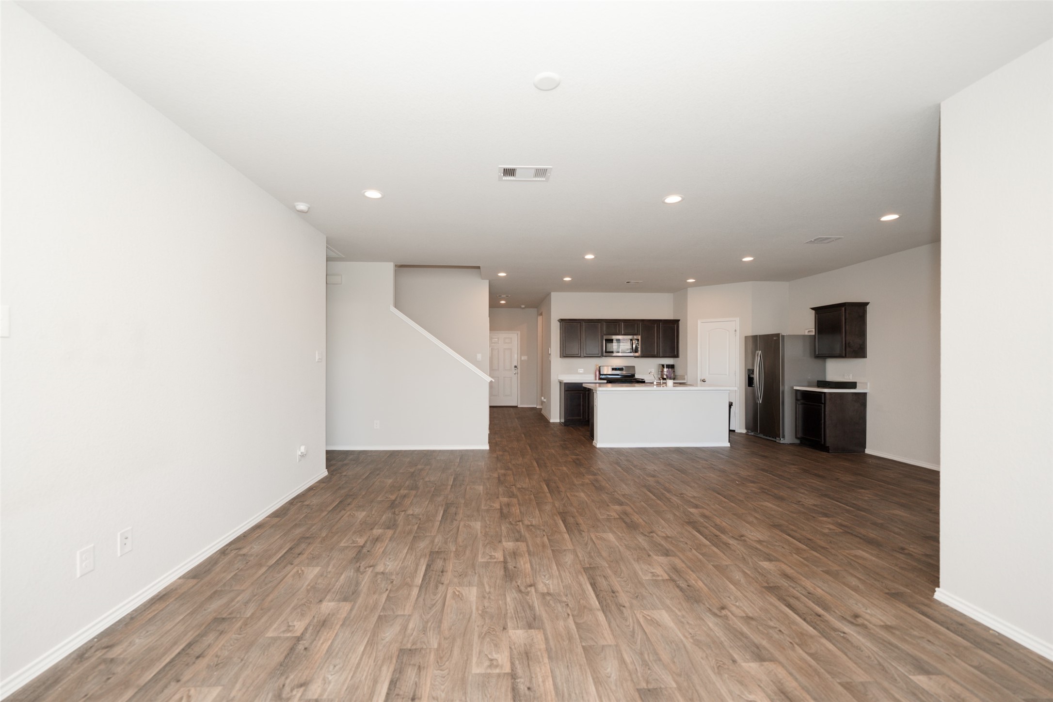 20818 Edmeston Way Katy, TX 77449 - Photo 16 of 32 a view of kitchen with kitchen island wooden floors and stainless steel appliances