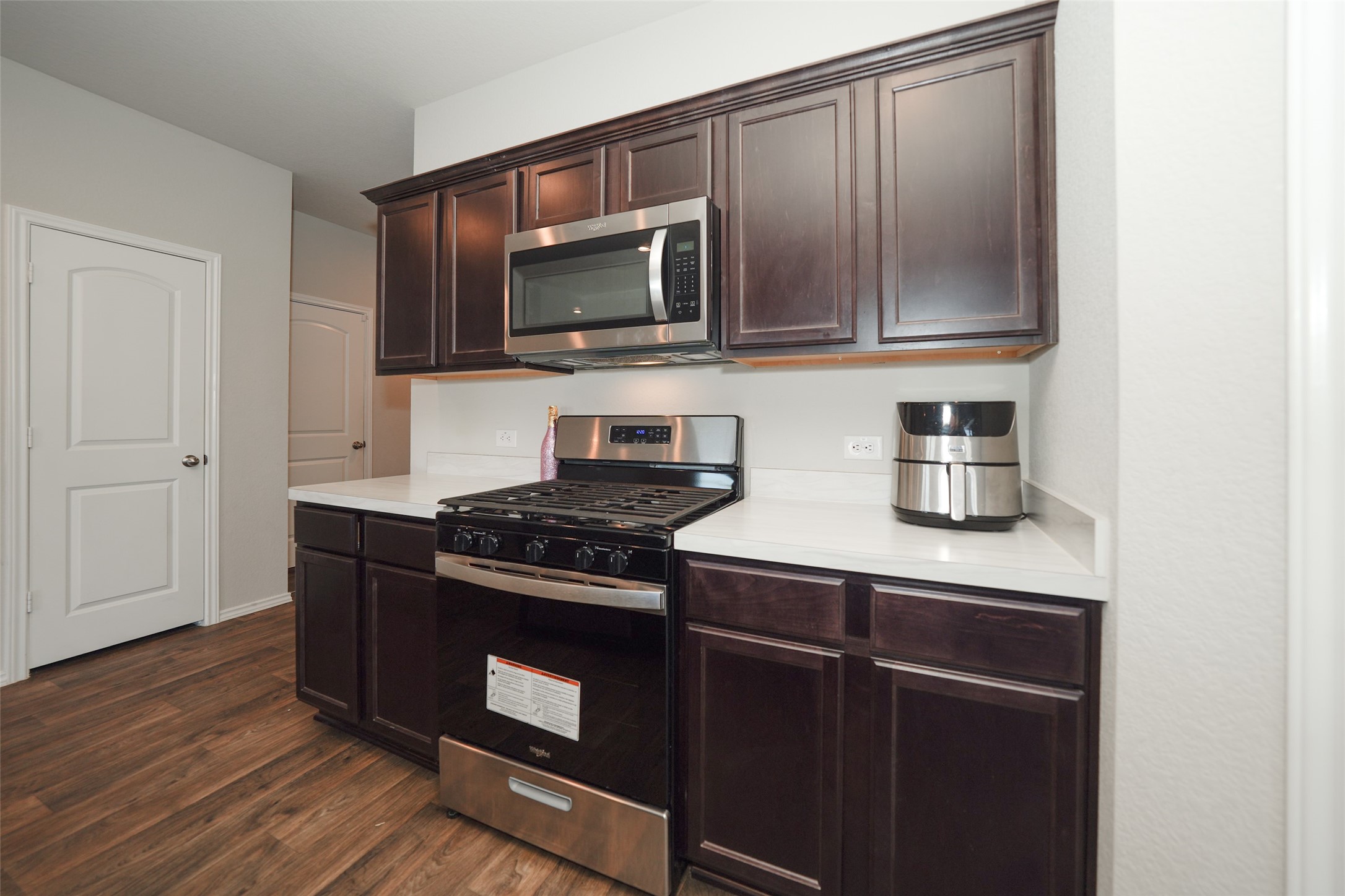 20818 Edmeston Way Katy, TX 77449 - Photo 18 of 32 a kitchen with stainless steel appliances granite countertop a stove and a microwave
