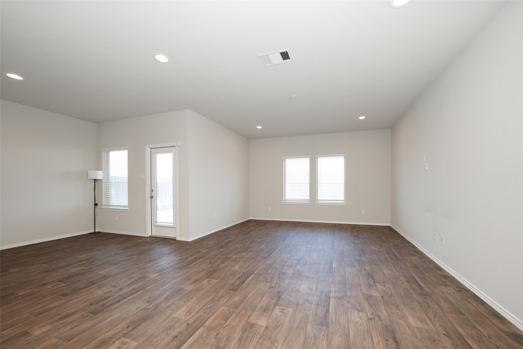 20818 Edmeston Way Katy, TX 77449 - Photo 21 of 32 an empty room with wooden floor and windows