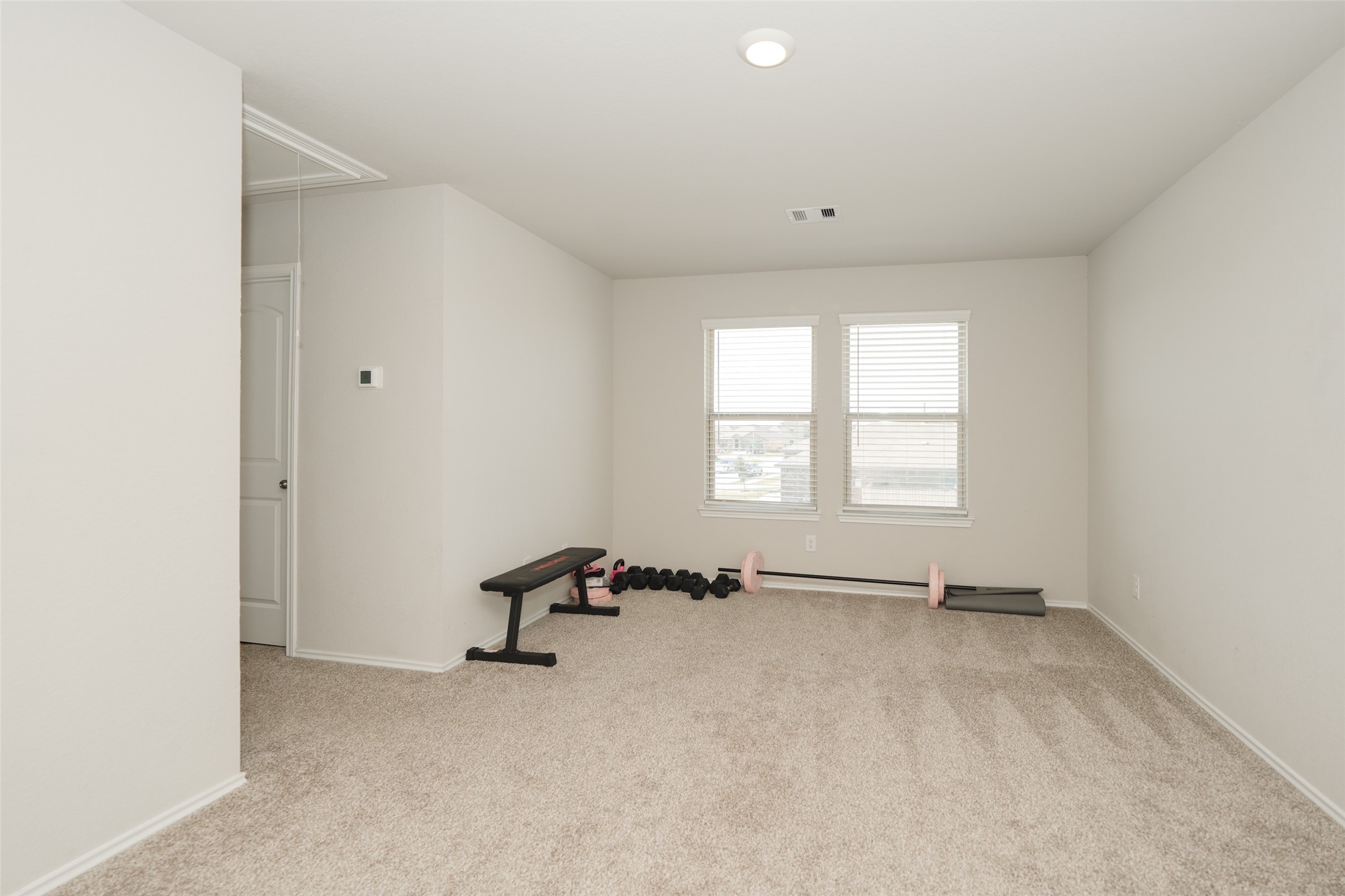 20818 Edmeston Way Katy, TX 77449 - Photo 26 of 32 an empty room with windows and mirror