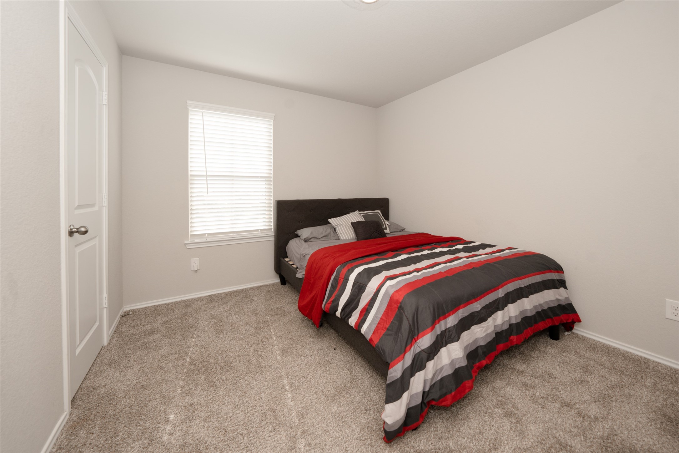 20818 Edmeston Way Katy, TX 77449 - Photo 28 of 32 a bed sitting in a bedroom next to a window