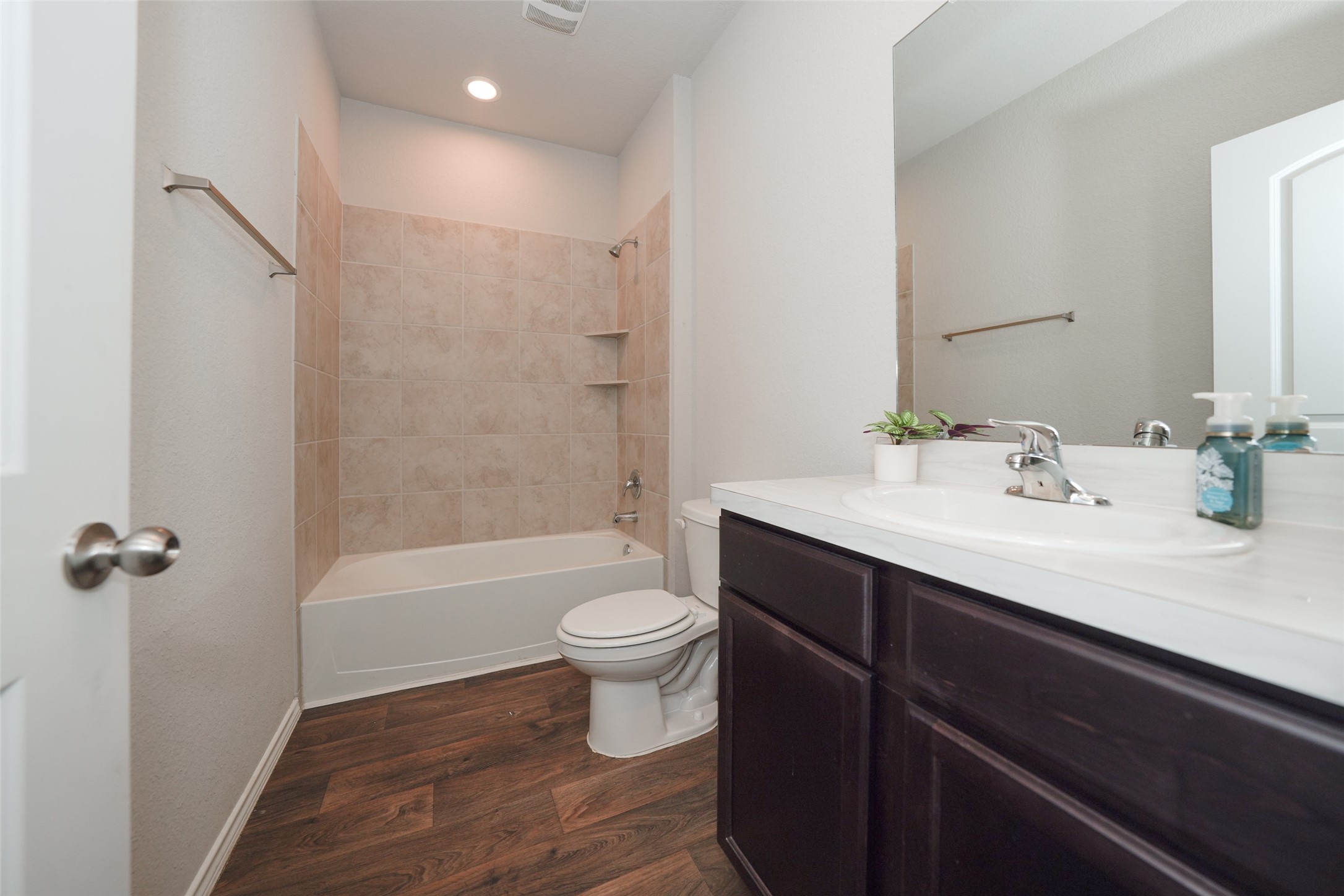 20818 Edmeston Way Katy, TX 77449 - Photo 7 of 32 a bathroom with a sink a toilet a mirror a bathtub and shower