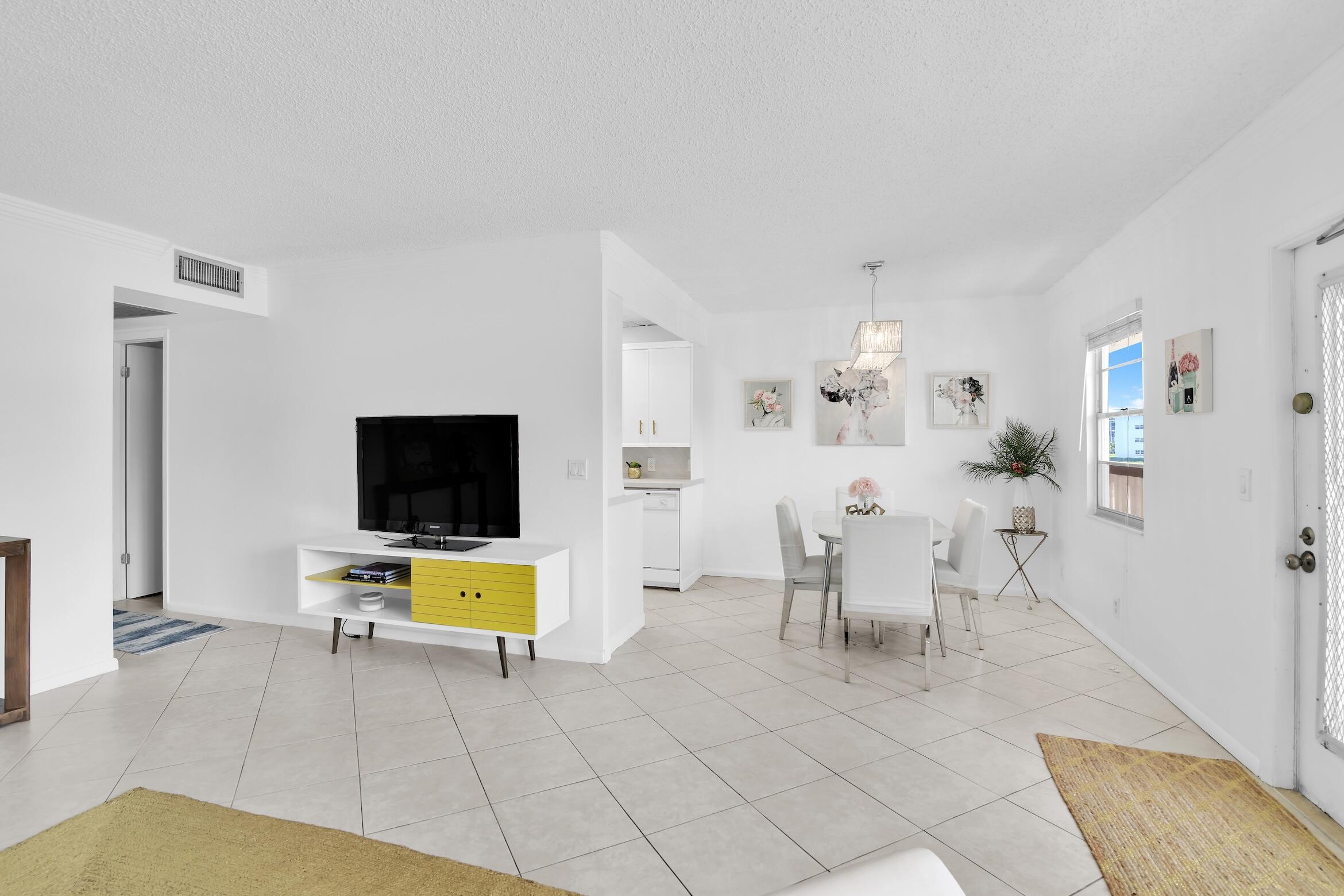 2043 Cornwall C, Unit 2043 Boca Raton, FL 33434 - Photo 2 of 22 a living room with furniture and a flat screen tv