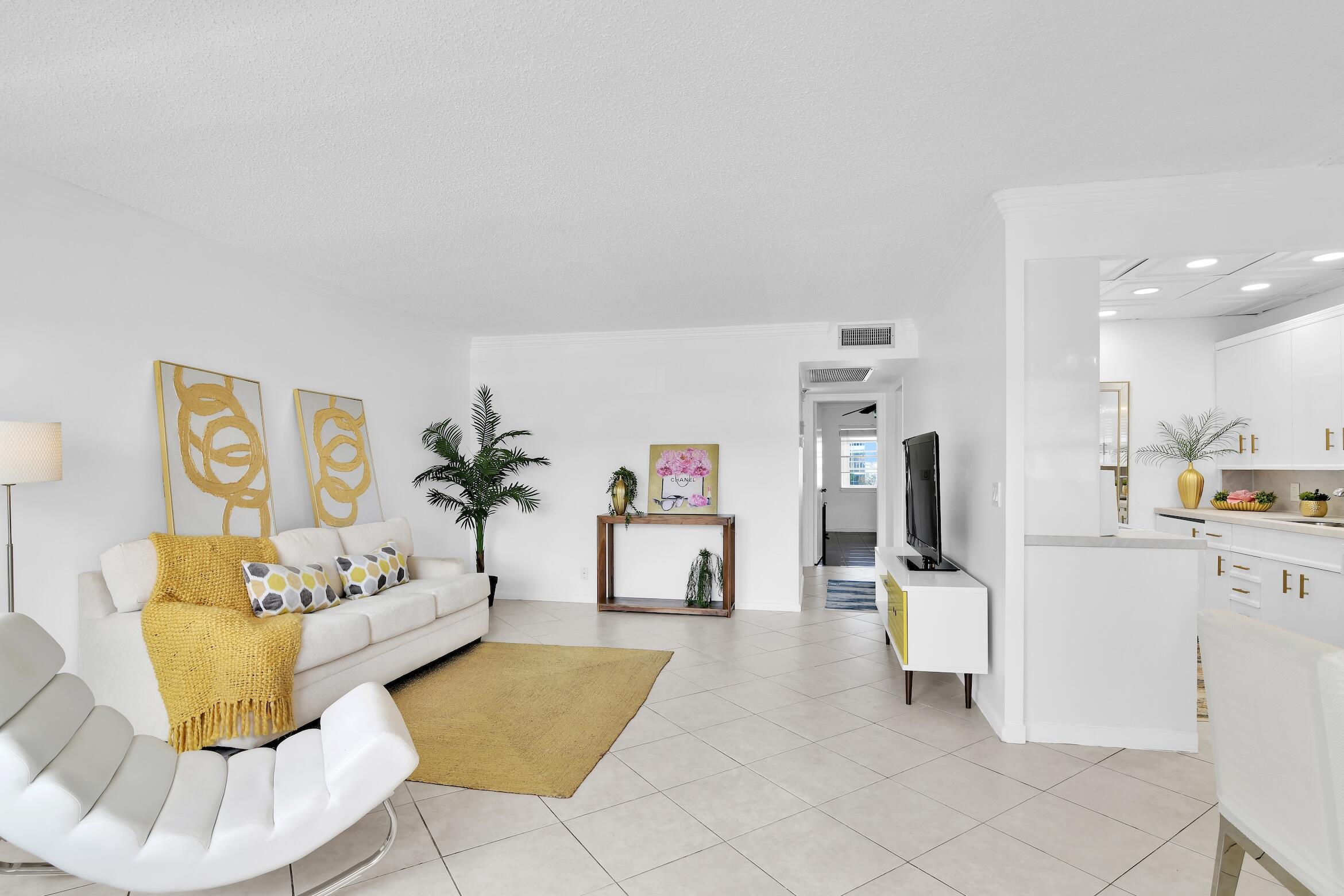 2043 Cornwall C, Unit 2043 Boca Raton, FL 33434 - Photo 3 of 22 a living room with furniture and a kitchen view