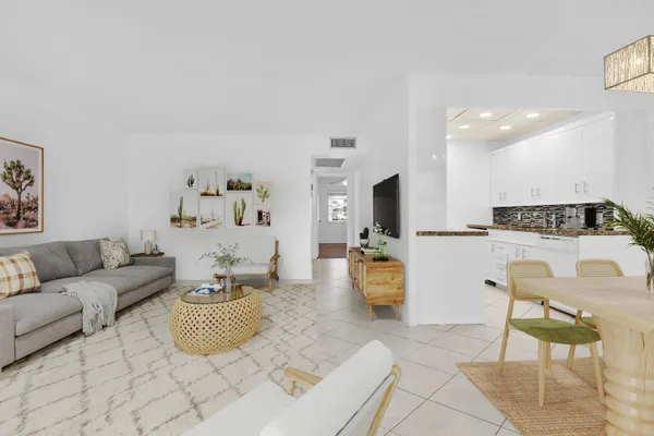 a living room with furniture and kitchen view