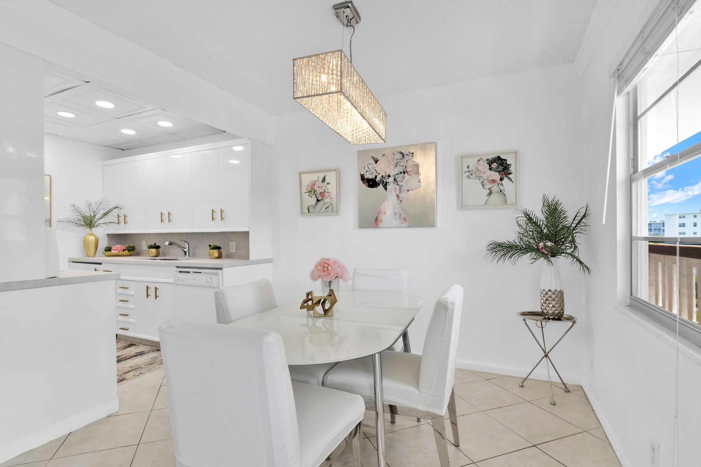 2043 Cornwall C, Unit 2043 Boca Raton, FL 33434 - Photo 6 of 22 a kitchen with a table and chairs in it