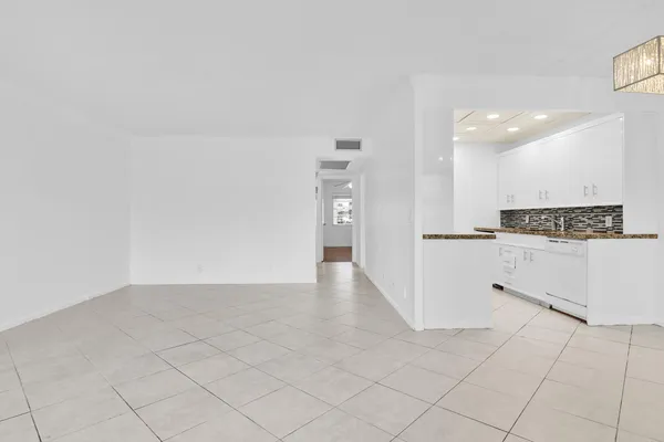 a view of kitchen with white cabinets