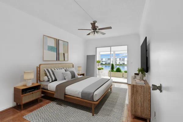 a bedroom with a bed couch and a chandelier