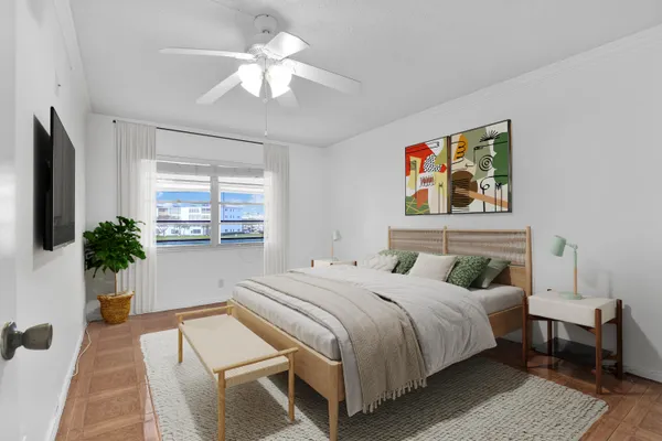 a bedroom with a bed a dresser next to a window