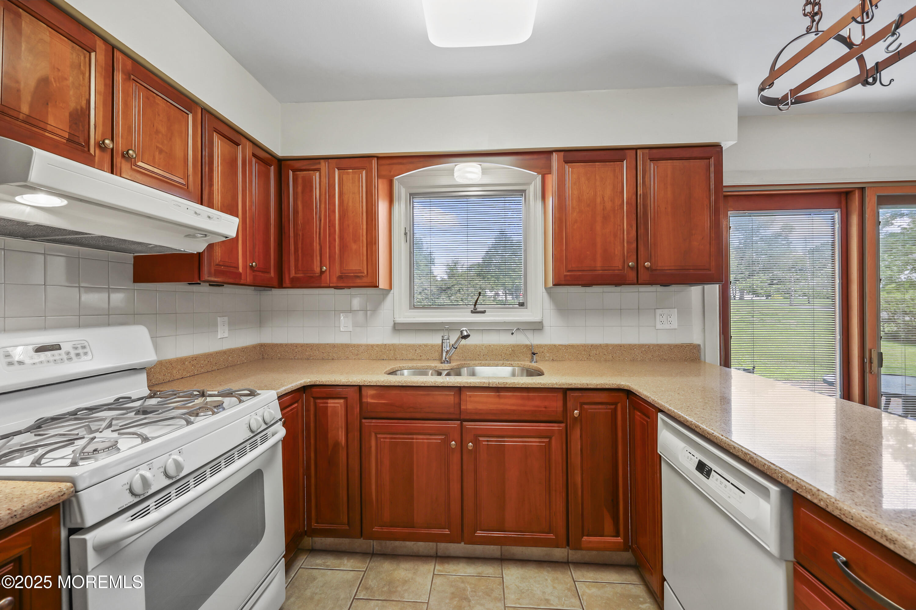 27 Sargent Road Freehold, NJ 07728 - Photo 13 of 47 a kitchen with stainless steel appliances granite countertop a sink stove and cabinets