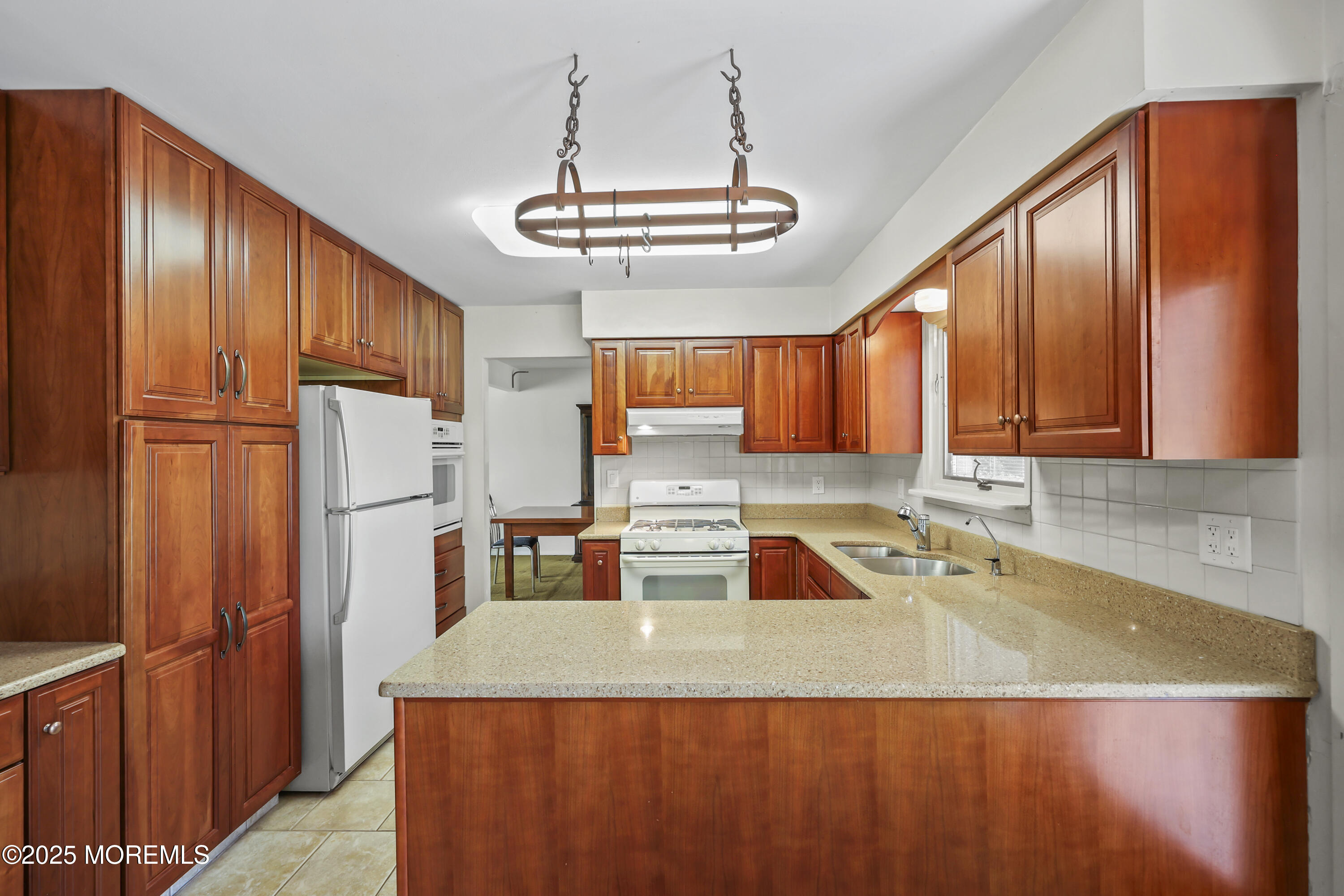27 Sargent Road Freehold, NJ 07728 - Photo 14 of 47 a kitchen with stainless steel appliances granite countertop a sink refrigerator and cabinets