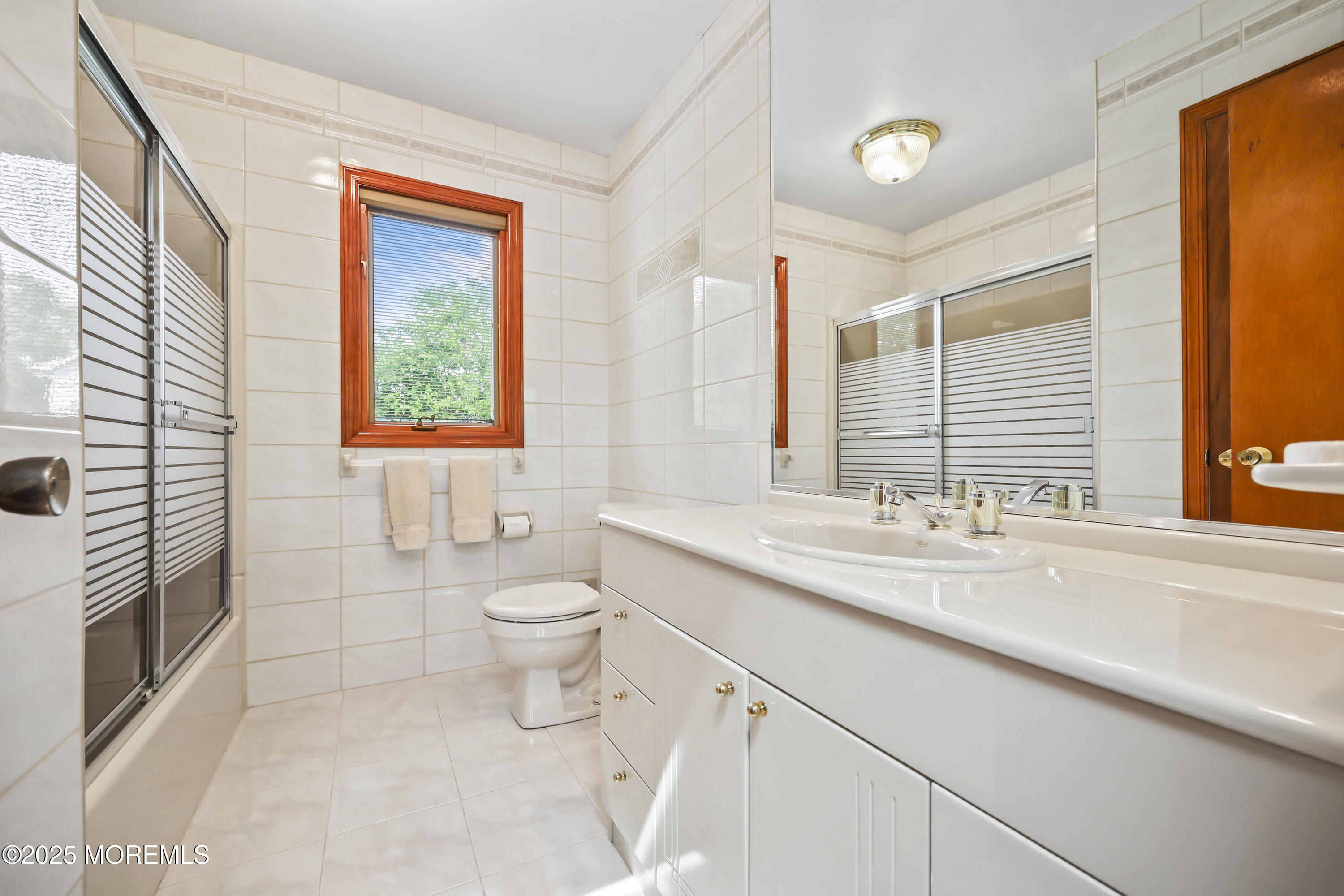 27 Sargent Road Freehold, NJ 07728 - Photo 31 of 47 a bathroom with a granite countertop toilet a sink and a large mirror