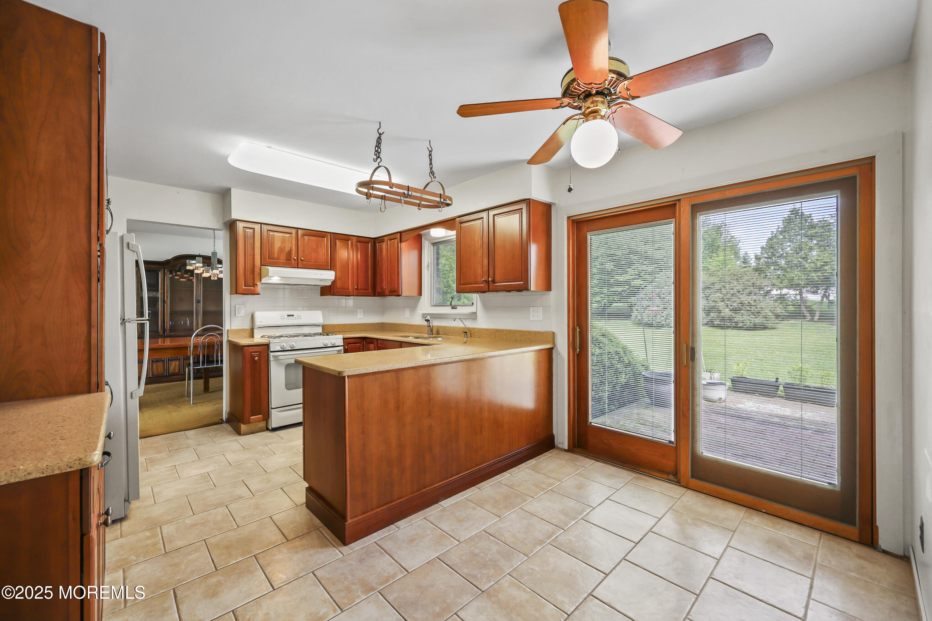 27 Sargent Road Freehold, NJ 07728 - Photo 10 of 47 a kitchen with stainless steel appliances granite countertop a stove a sink and a refrigerator