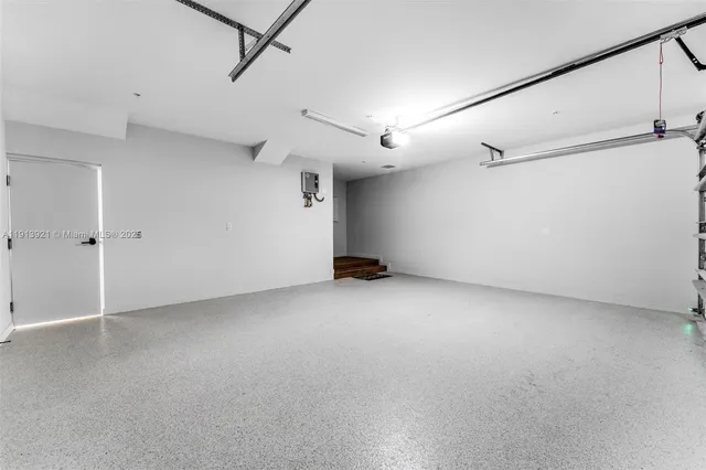an empty room with a ceiling fan and windows