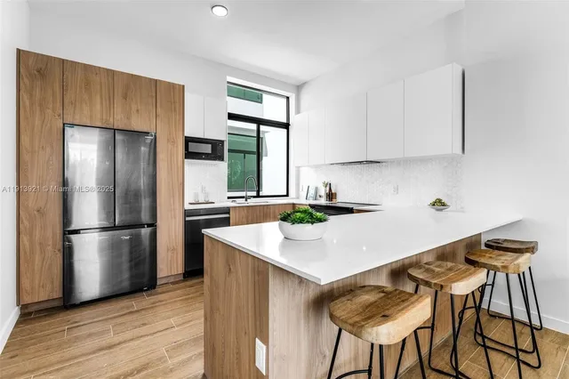 a kitchen with appliances a counter space and a window