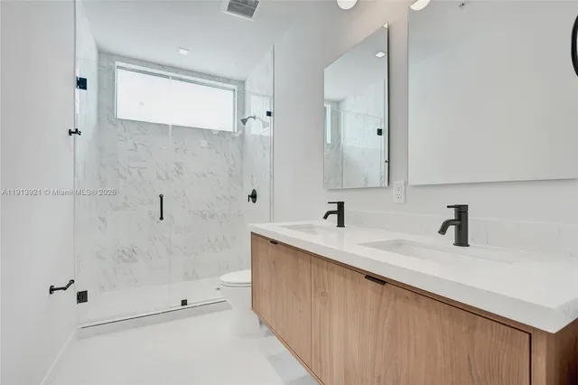 a bathroom with a sink double vanity and shower