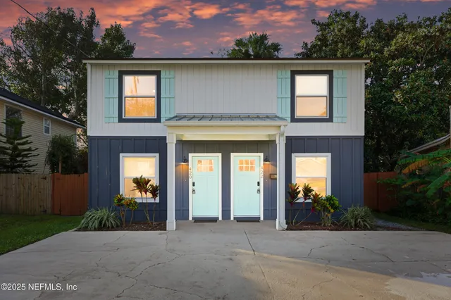 a front view of a house with a garden