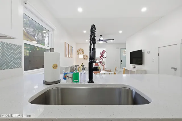 a kitchen with kitchen island a sink and a refrigerator