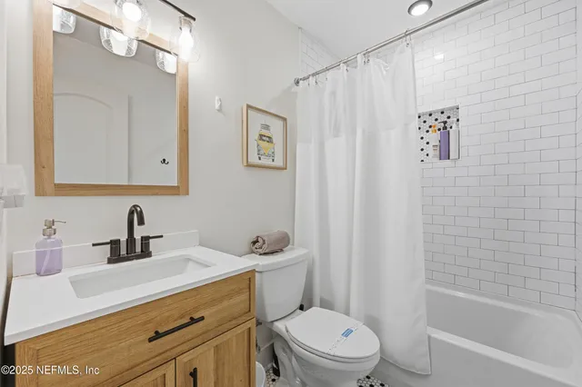 a bedroom with a bed a mirror and a desk